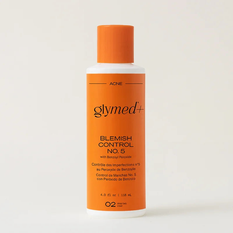Orange bottle of Glymed+ Blemish Control No. 5 on a beige background